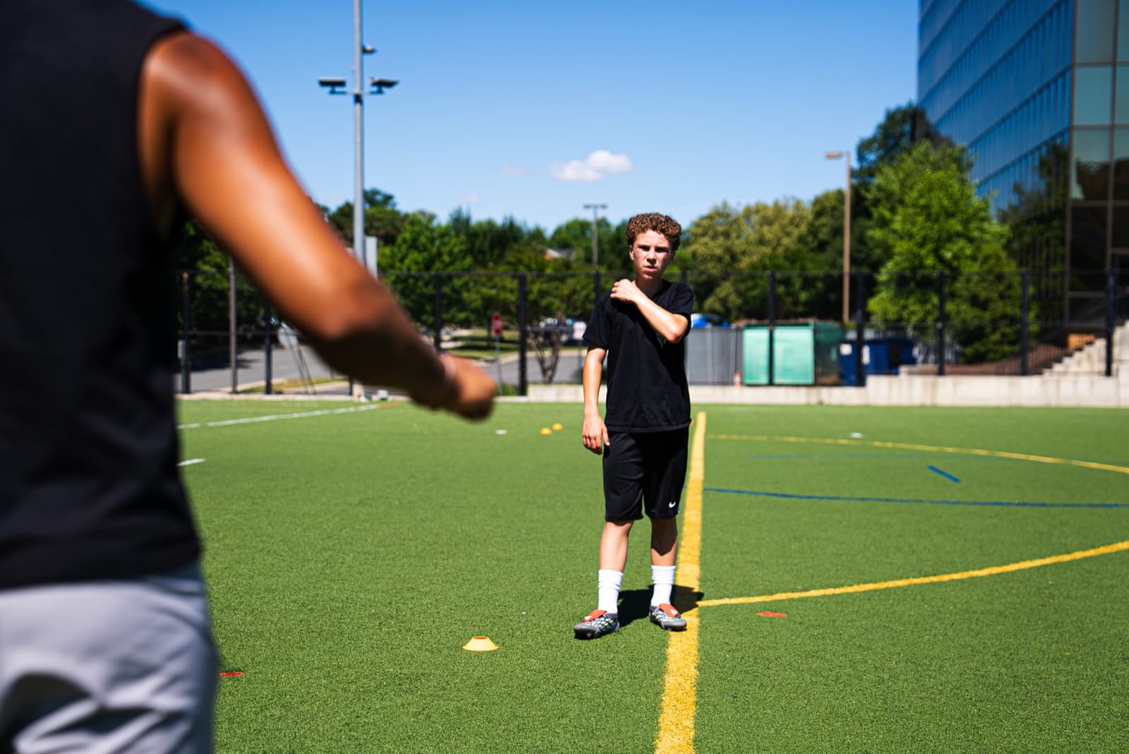 Coach and player working through a passing pattern on a Northern Virginia turf field